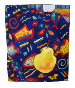 golden pear nestled on hieroglyph like fabric