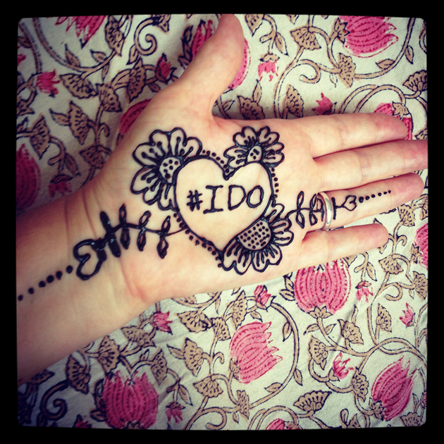 henna hand with #ido and background of flower fabric