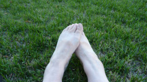 happy bare feet on very green grass