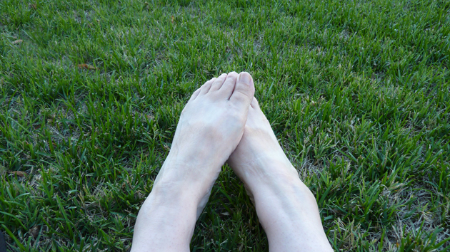 happy bare feet on very green grass