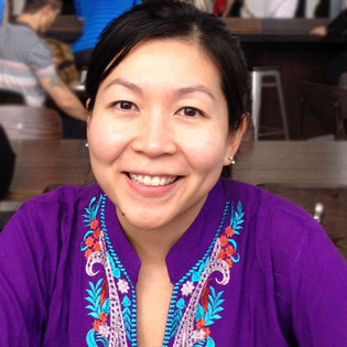 Juanita Tortilla smiling, looking at camera, wearing a purple top
