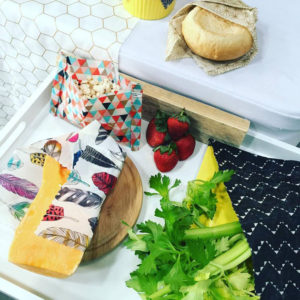 Ploughman's Lunch with bread, cheese, celery, strawberries and popcorn, arranged with patterned food wraps.