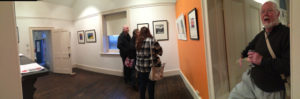 gallery patrons discussing art at a gallery launch