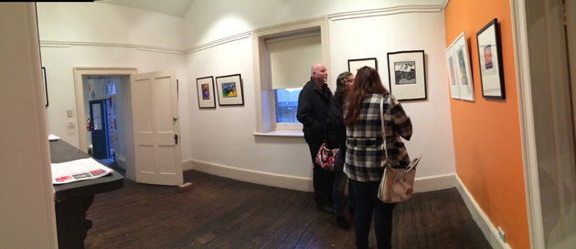 gallery patrons discussing art at a gallery launch