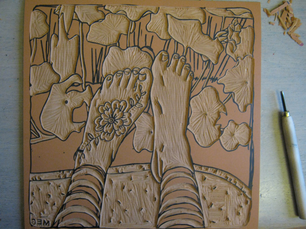 Lino tool alongside carved lino block picture of feet
