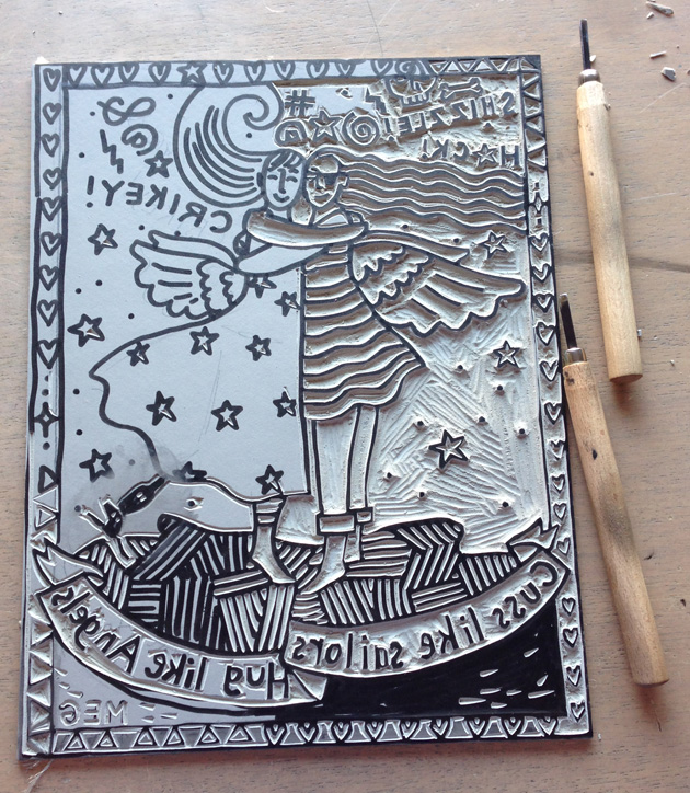 Photo of lino block, half carved, with 2 lino tools alongside