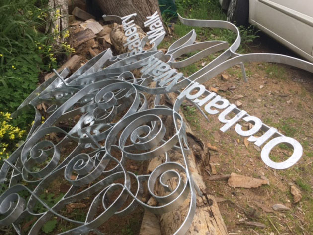 Curlicues and lettering made of metal in a pile