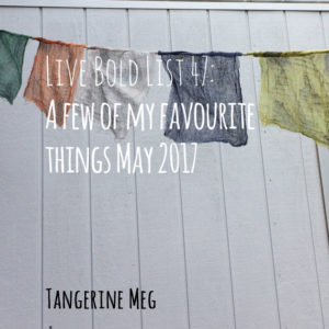 Header text in handwritten looking font, overlaid on a panelled pale grey wall with prayer flags hanging across the top third.