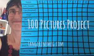 Tangerine Meg's face at left, looking towards a grid drawn on blue paper, a chart to track the progress of the 100 Pictures Project